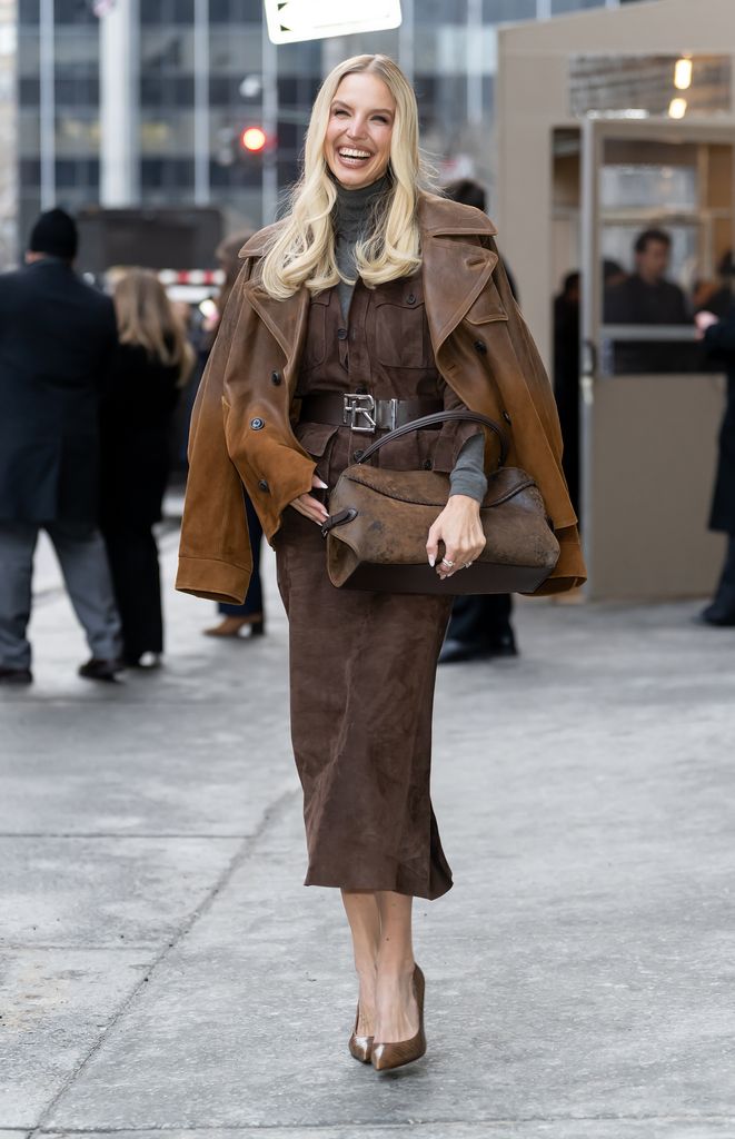 Leonie Hanne wears a brown midi skirt, brown heels and matching brown jacket