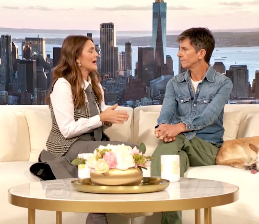 Drew Barrymore and Tig Notaro sat on cream sofa on The Drew Barrymore Show