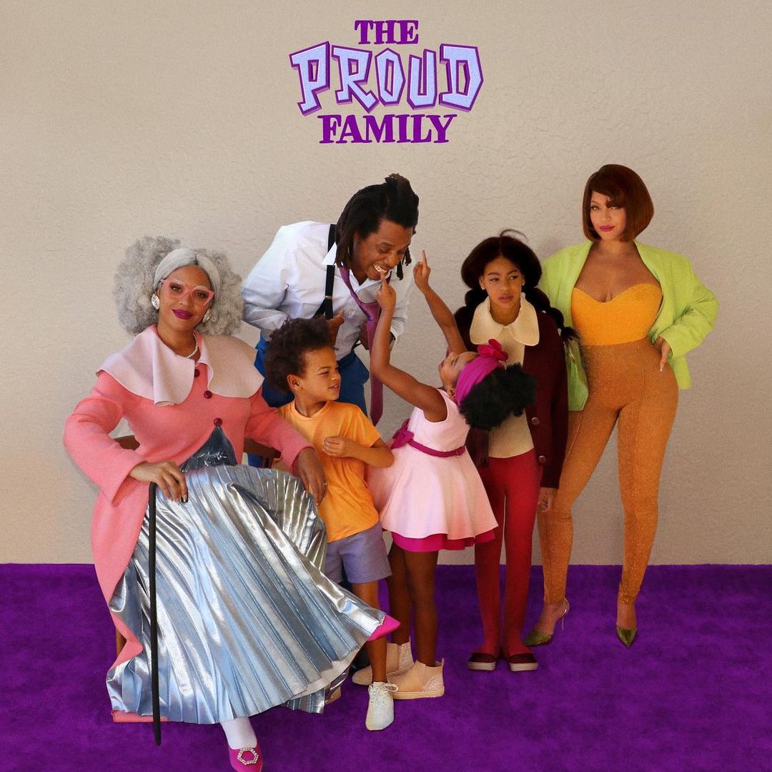 The family together for Halloween dressed up as the Proud family