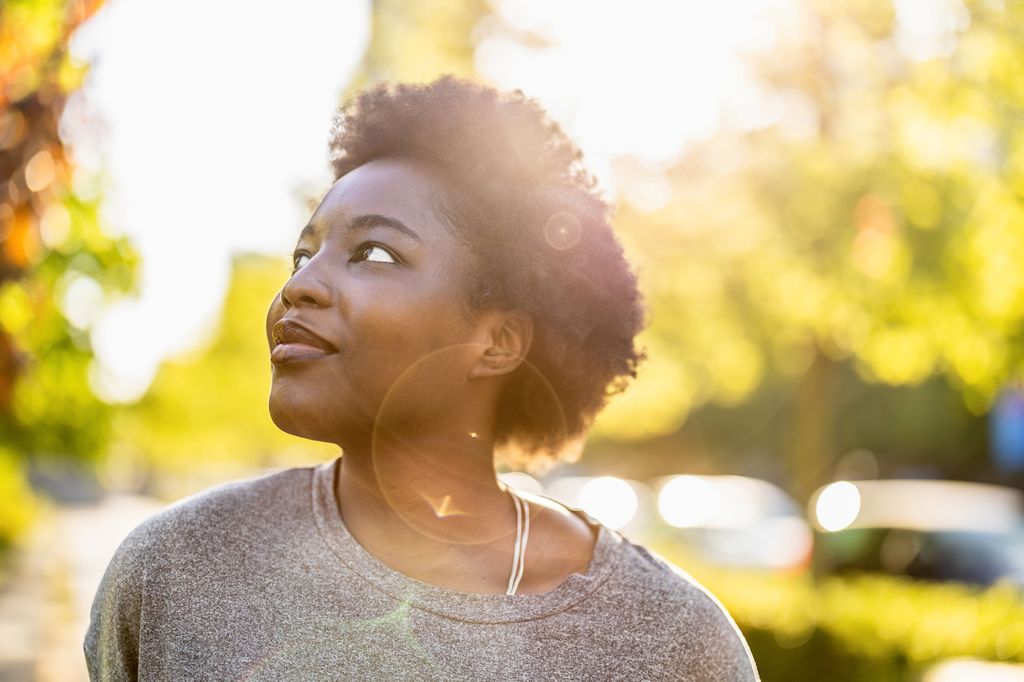 woman taking a walk in sunshine to lower cortisol