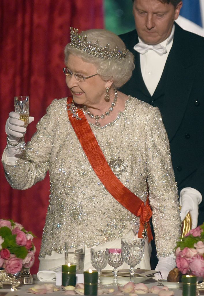 Queen Elizabeth ll  raises her glass for a toast during  a State Banquet hosted by Franch President Francois Hollande at the Elysee Palace on June 6, 2014 in Paris