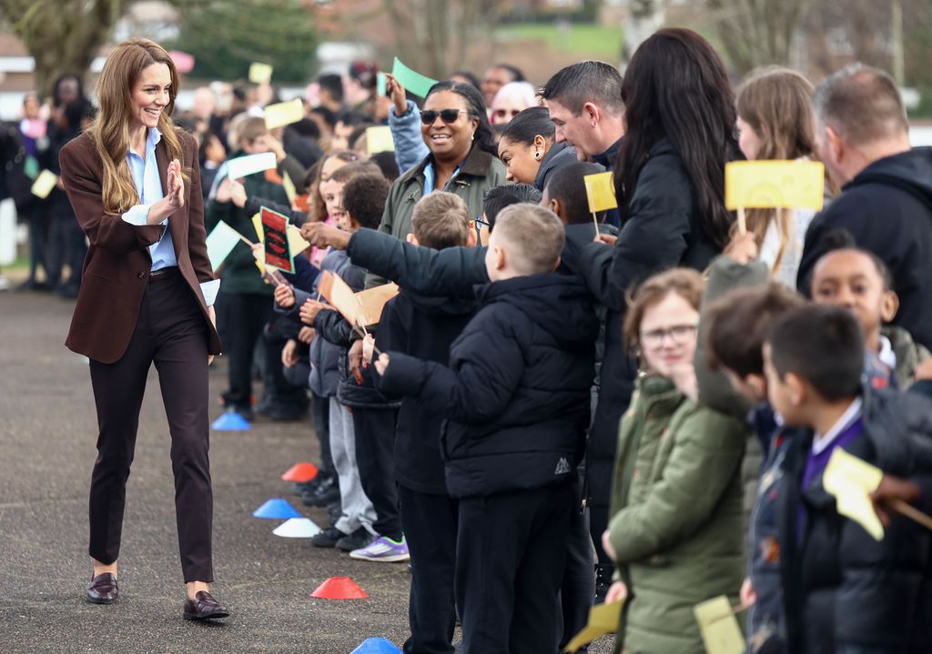 The Princess of Wales in a brown suit on school playground