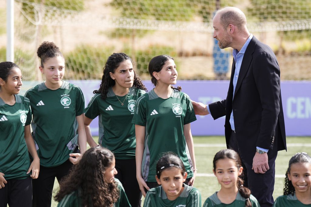 Prince William speaks with a group of young female footballers during a visit to MISK Sports City in Riyadh