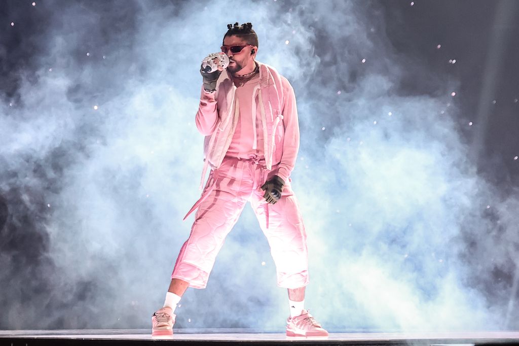 photo of bad bunny on stage in pink outfit