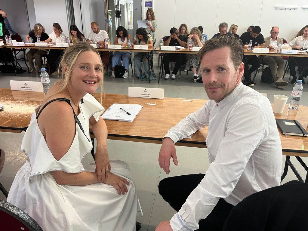female and male actor sitting at table for read through