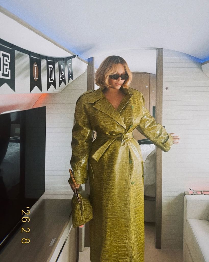 A photo of Beyonce wearing a green coat with a bob hairstyle