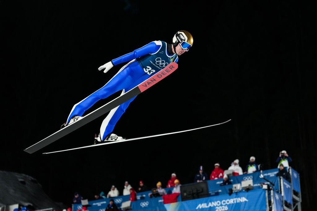 Timi Zajc of Slovenia jumps during the men's ski jumping in his blue outfit 