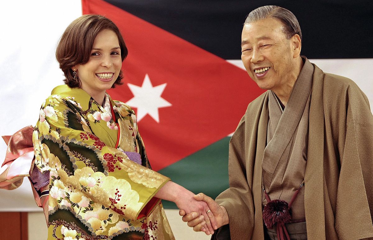 Jordan's Princess Raiyah wearing a Japanese traditional silk kimono as she shakes hands with chairman of Sodo Reiho Kimono Dressing Academy Norio Yamanaka during her visit to the academy in Tokyo in 2009