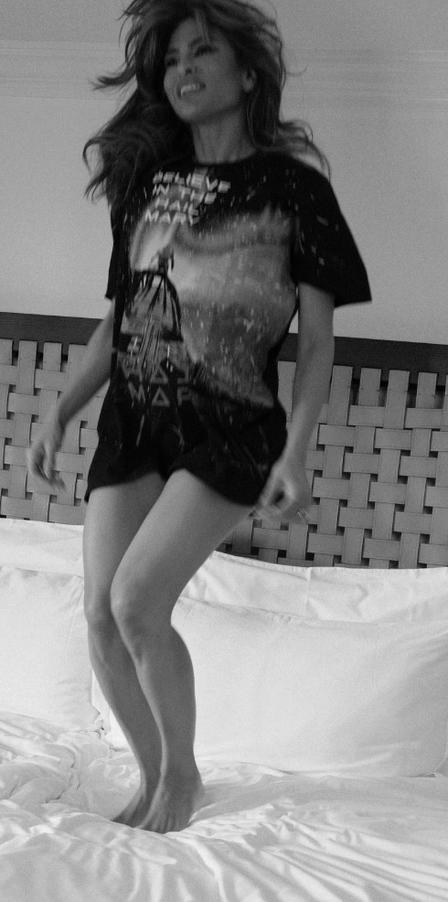 Eva is seen jumping on the bed in intimate photos