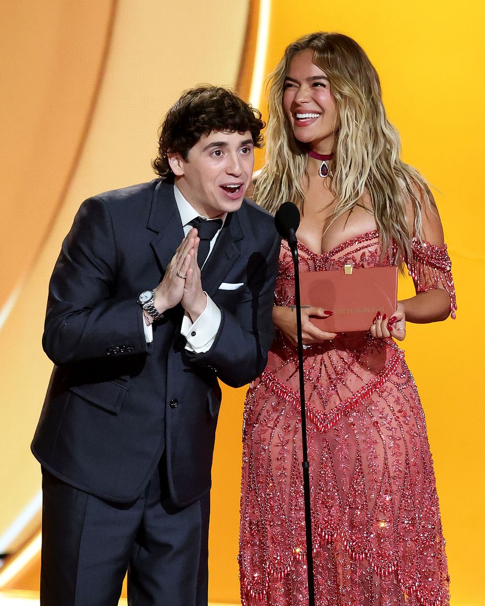 Marcello Hernandez and Karol G speak onstage during the 68th GRAMMY Awards.