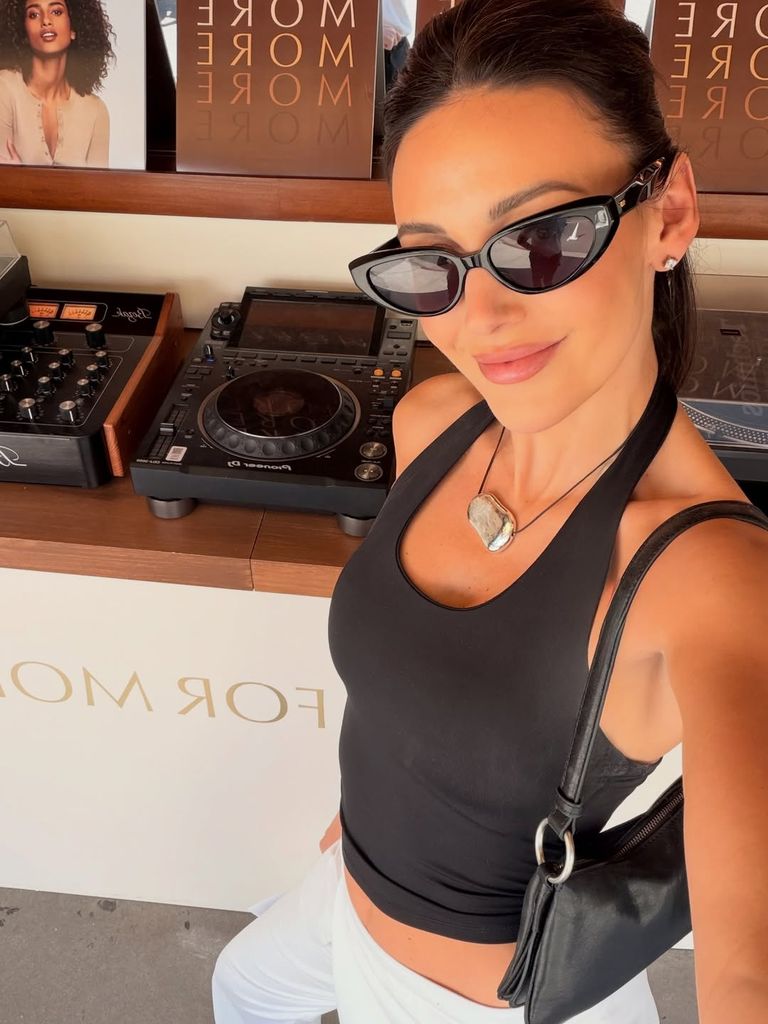 A photo of Michelle Keegan wearing a black halterneck top