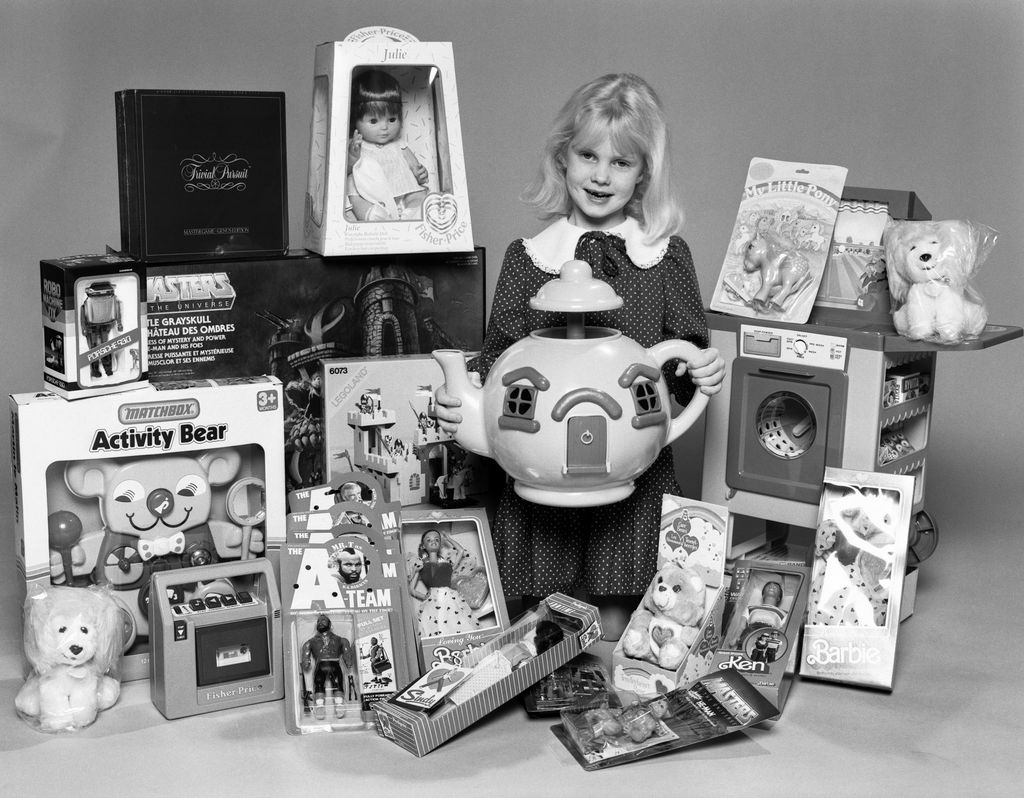 A young girl with a selection of children's toys for Christmas, 6th December 1984. (Photo by Peter Cook/Daily Mirror/Mirrorpix/Getty Images)
