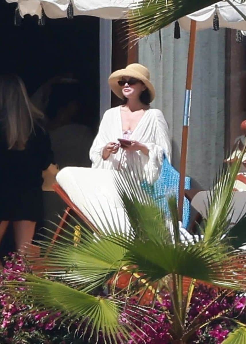 The singer and beauty mogul looked relaxed and radiant as she dipped her toes in the ocean and unwound under a private cabana.