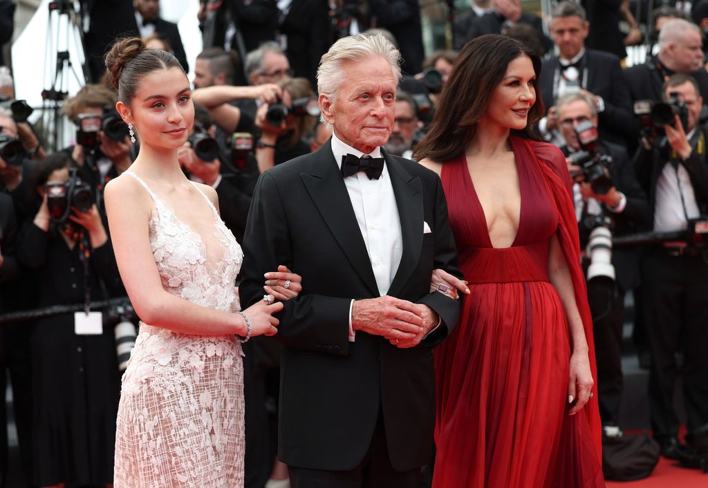 Carys Zeta Douglas in pink dress, Michael Douglas in suit and Catherine Zeta-Jones in red dress