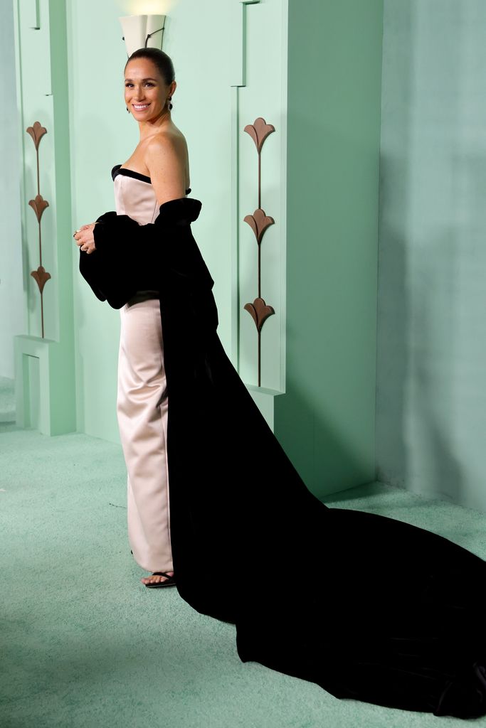 Meghan in strapless gown with long black shawl