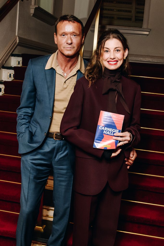 Tim McGraw in blue suit and Faith Hill in burgundy blazer