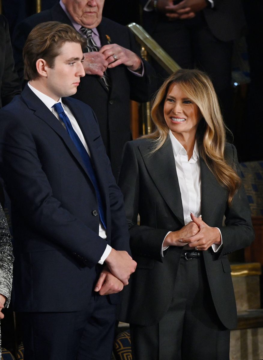 First Lady Melania Trump made a rare but commanding appearance in a sharply tailored dark gray pantsuit from Dolce & Gabbana. 