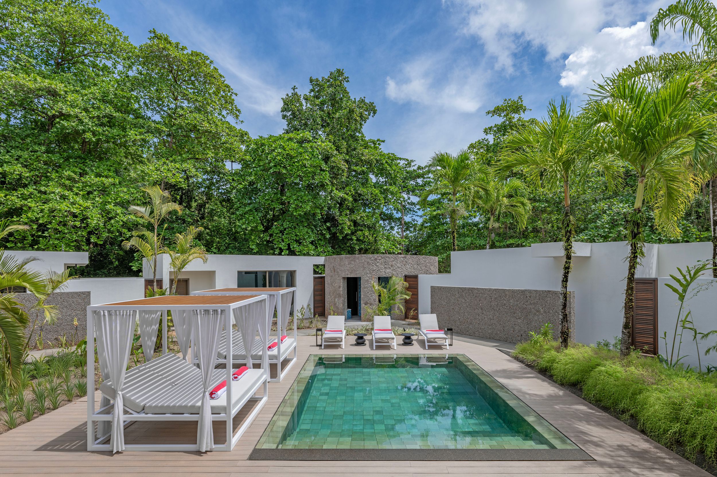 A private swimming pool surrounded by sun lounders