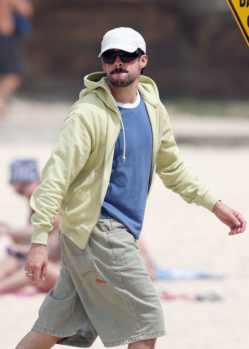 Bad Bunny was spotted arriving in Sydney after reportedly chartering a Qantas superjumbo for his crew, swapping first-class suites for first-class flip-flops as he made his way through arrivals.