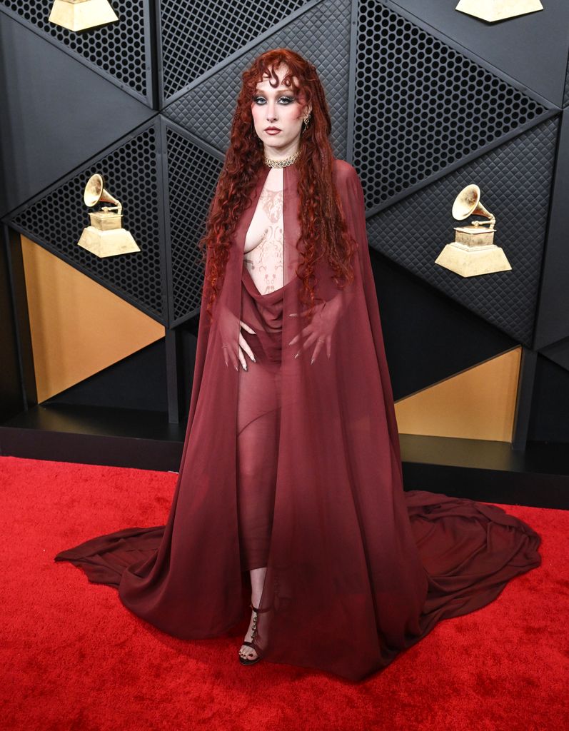 Chappell Roan in an oxblood sheer cape with plunging skirt
