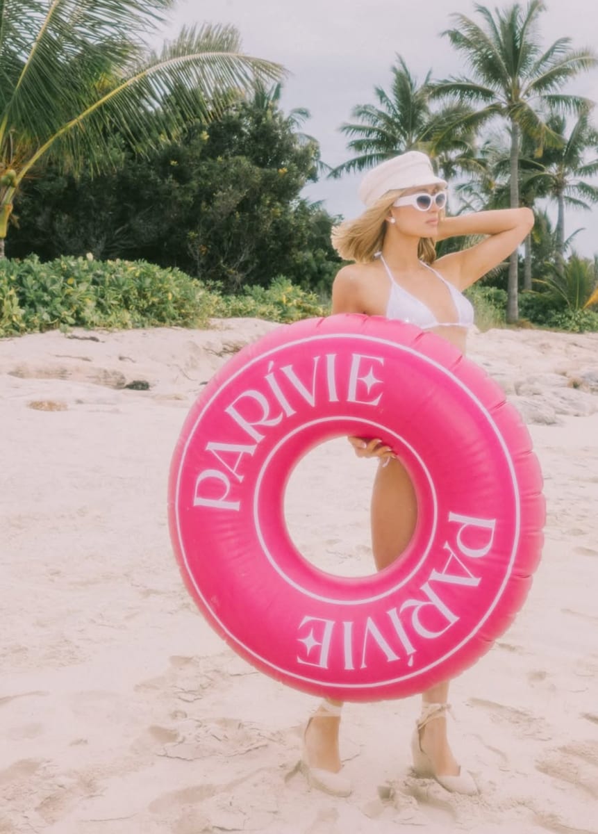 The birthday photos show Hilton strolling across the white sands of St. Barts in a classic white string bikini.