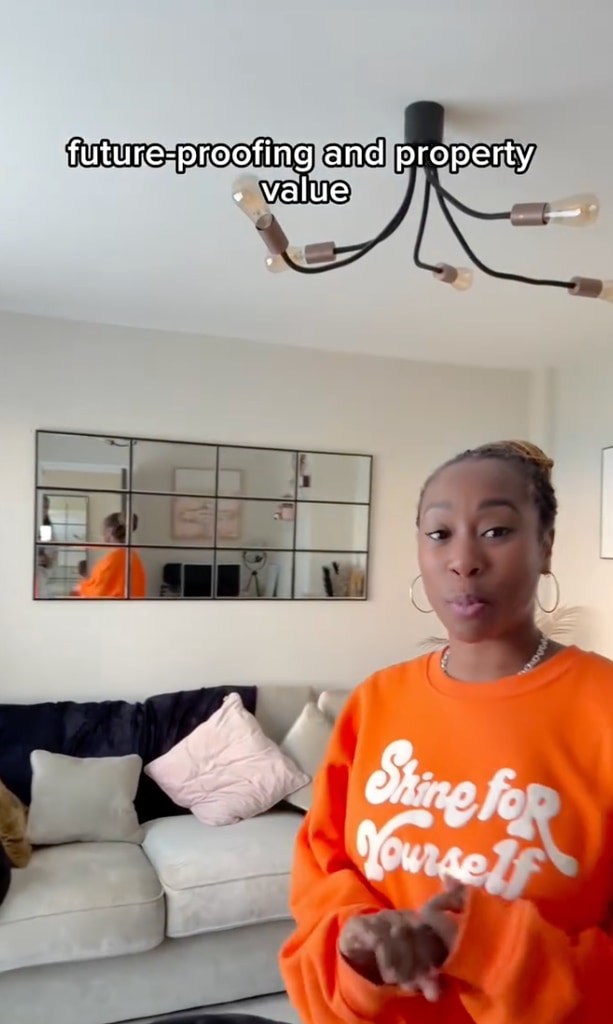 woman in orange jumper at home