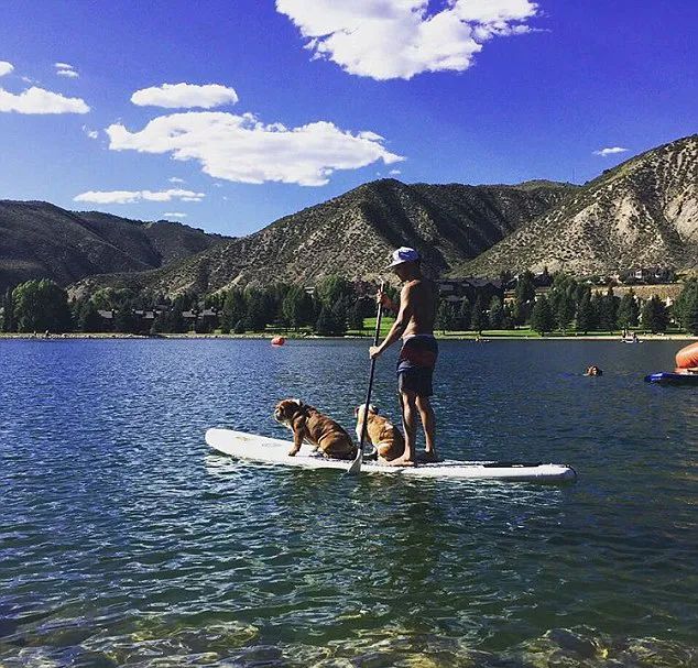 Lewis on lake with dogs on paddleboard