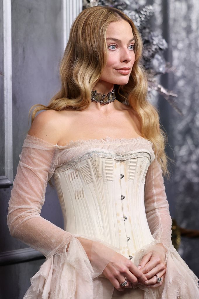 A photo of Margot Robbie wearing an off the shoulder dress 