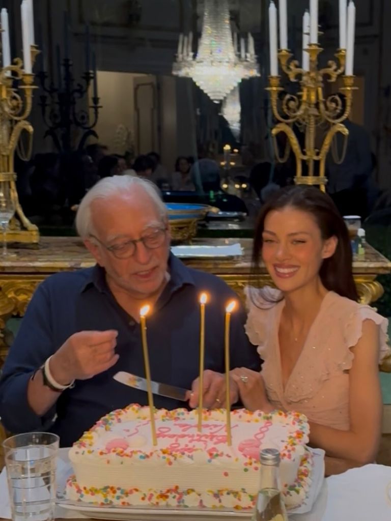 Nicola Peltz with father Nelson blowing out birthday candles