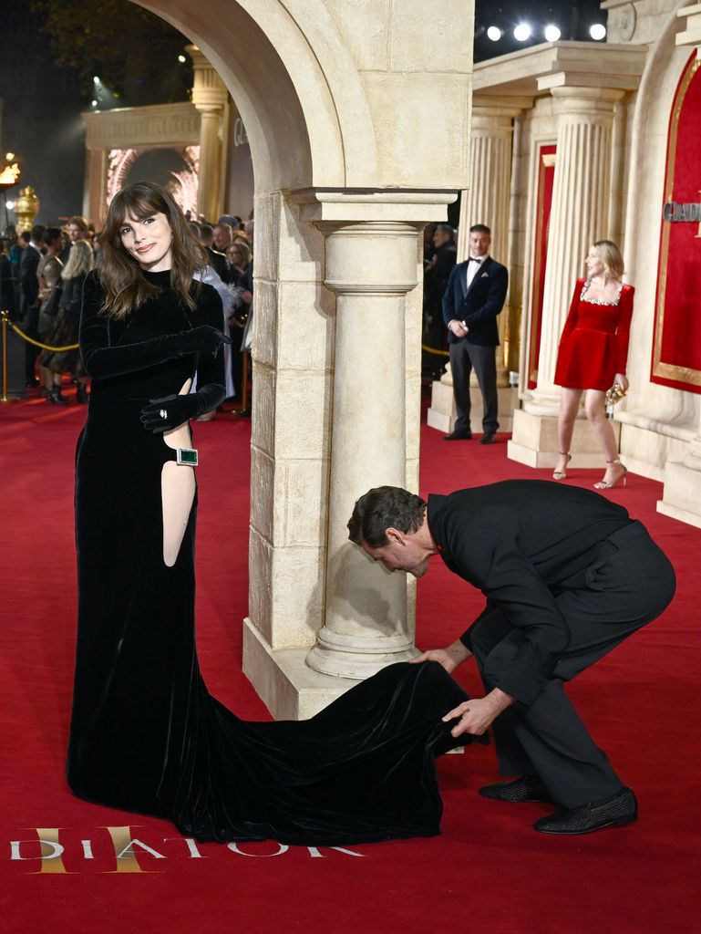 A photo of Pedro Pascal adjusting Lux's dress 