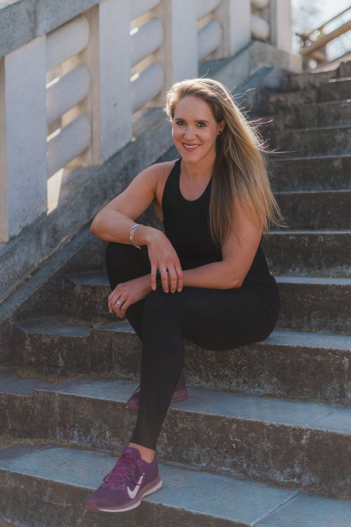 woman in activewear sitting on steps 