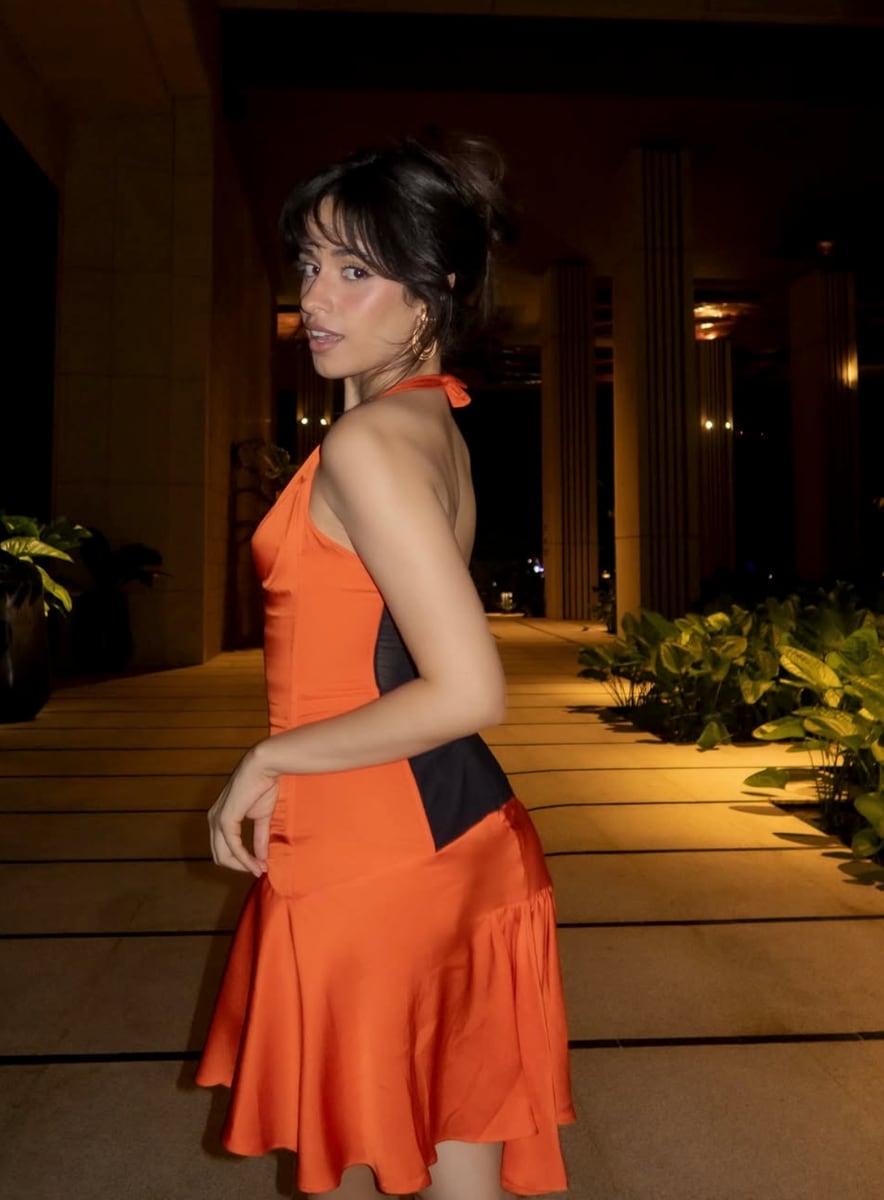 Camila's flirty look was completed with a flowing asymmetrical skirt that gave the piece a romantic, almost retro twist.