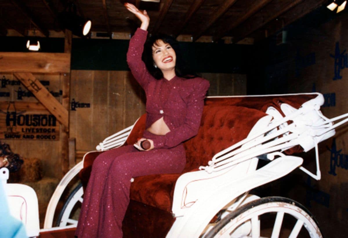Selena Quintanilla-Pérez rides in a carriage during her performance at the Houston Livestock Show & Rodeo at the Houston Astrodome on February 26, 1995.