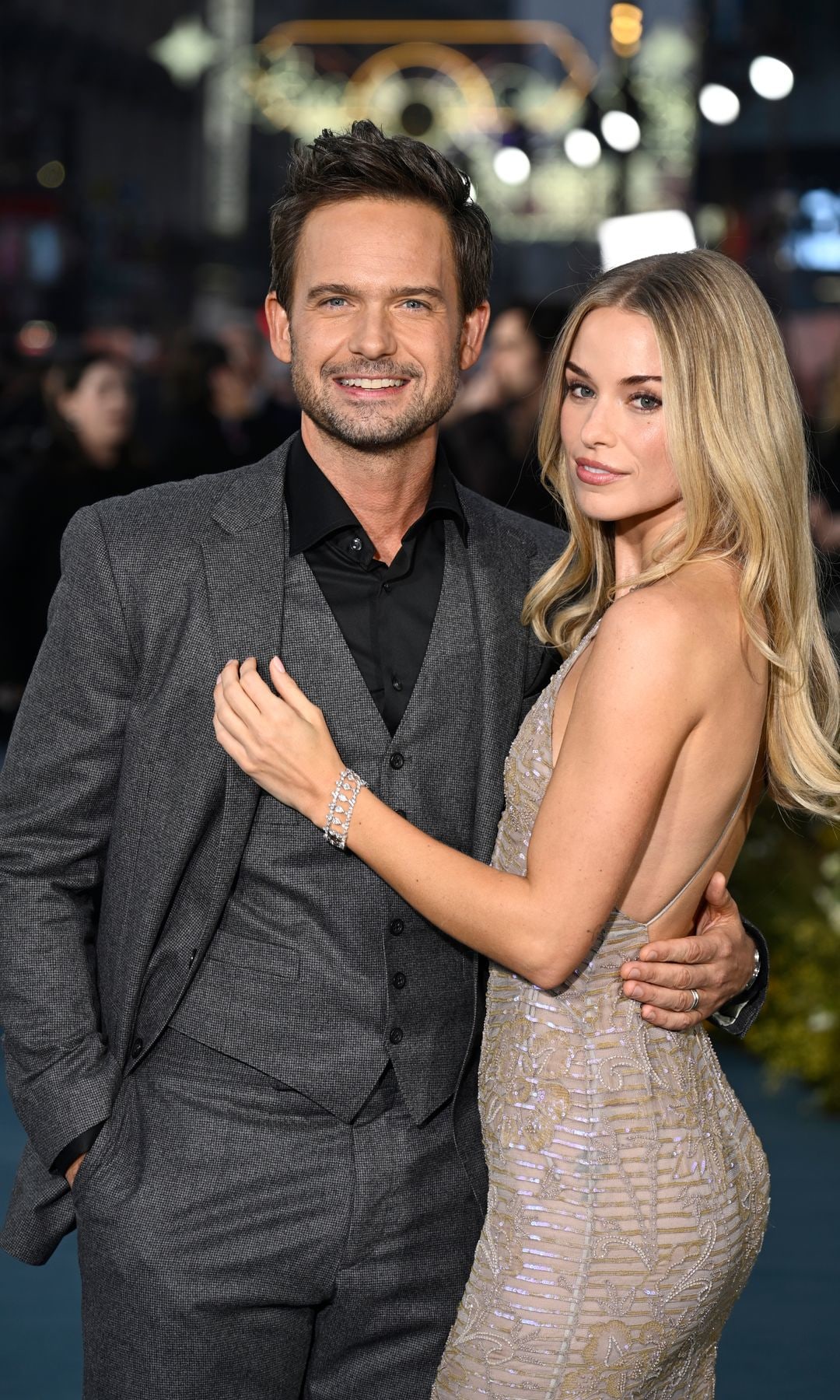 Patrick J. Adams with his arm around Elle Chapman