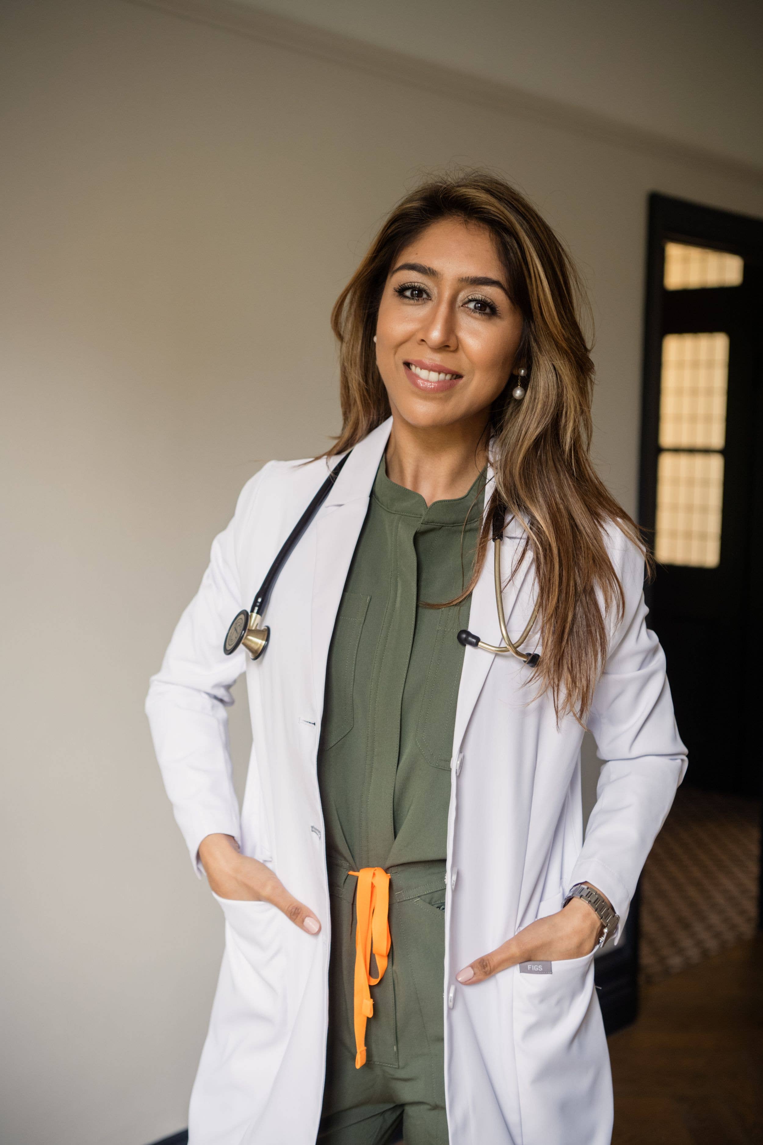 smiling woman in a doctor's lab coat