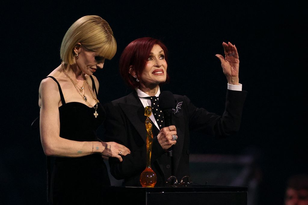 Sharon Osbourne (R) and Kelly Osbourne accept the Lifetime Achievement Award on behalf of the late English singer Ozzy Osbourne during the BRIT Awards 2026 