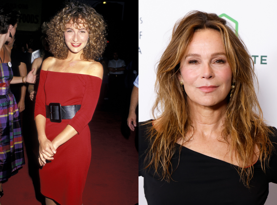 Jennifer Grey clasping her hands in front of her, wearing an off the shoulder red dress with a thick statement belt smiling at the camera. To the right, in modern day wearing a black dress with an asymmetric neckline.
