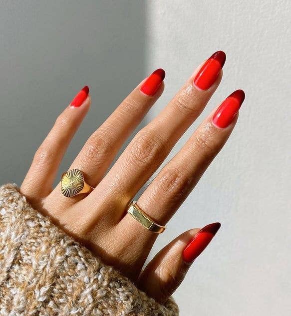 Red and chocolate brown nail design creating an elongating effect.