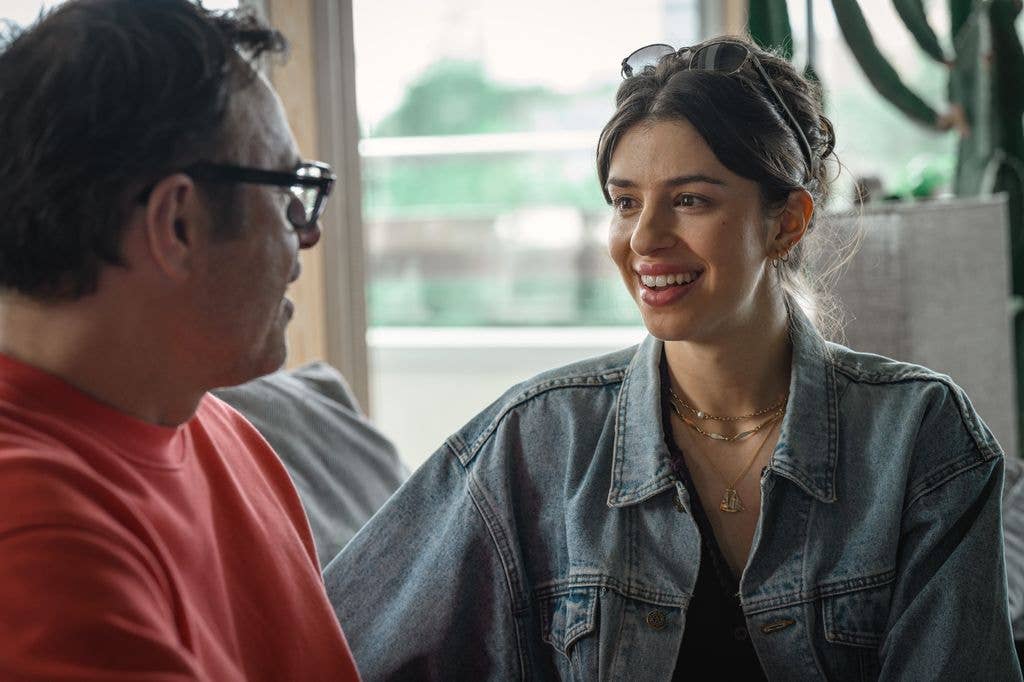 young woman and older man sitting on sofa