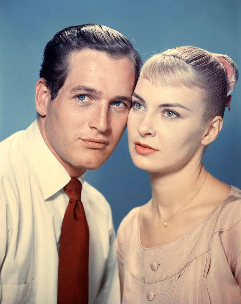 Paul Newman and Joanne Woodward rest the sides of their heads together in a 1958 promotional image.