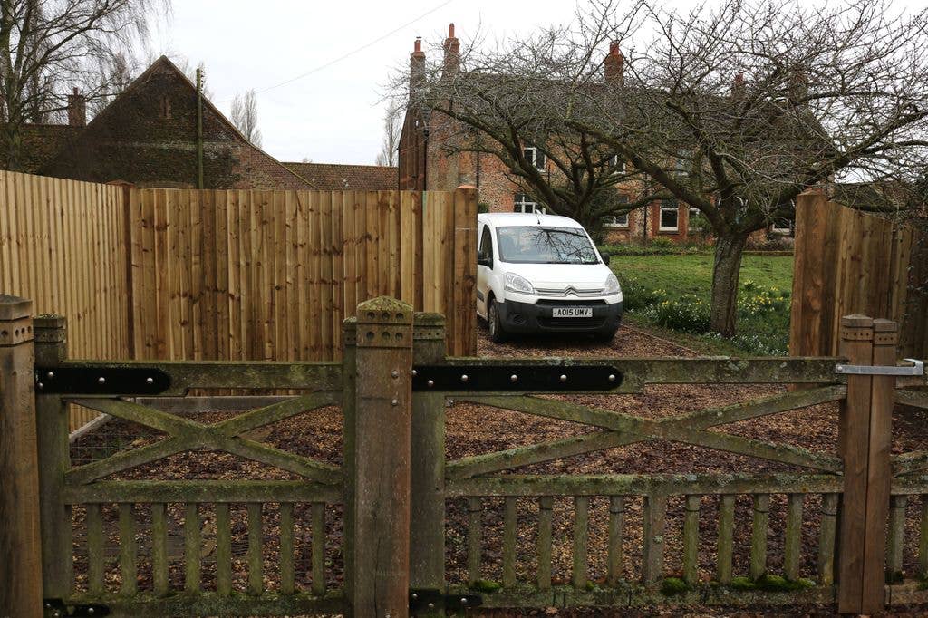 house with fence and van