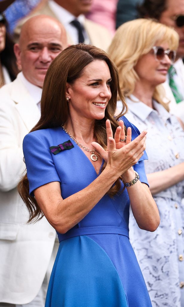 Catherine, Princess of Wales clapping in royal blue dress 