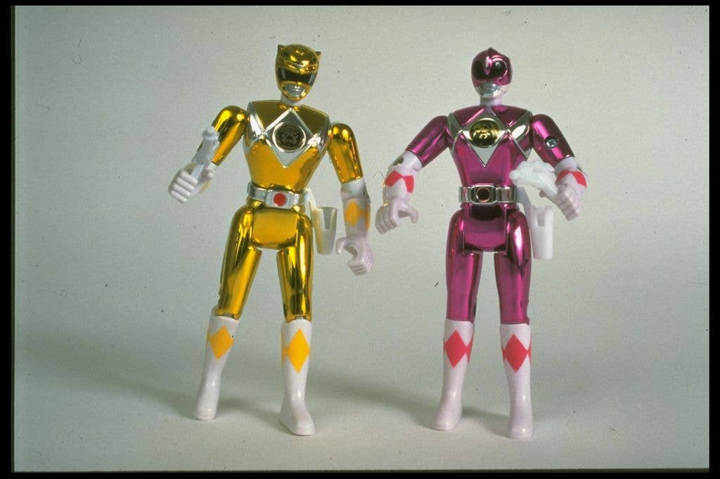 Two shiny Power Rangers in yellow and pink.