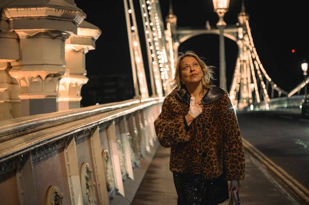 woman walking over bridge at night