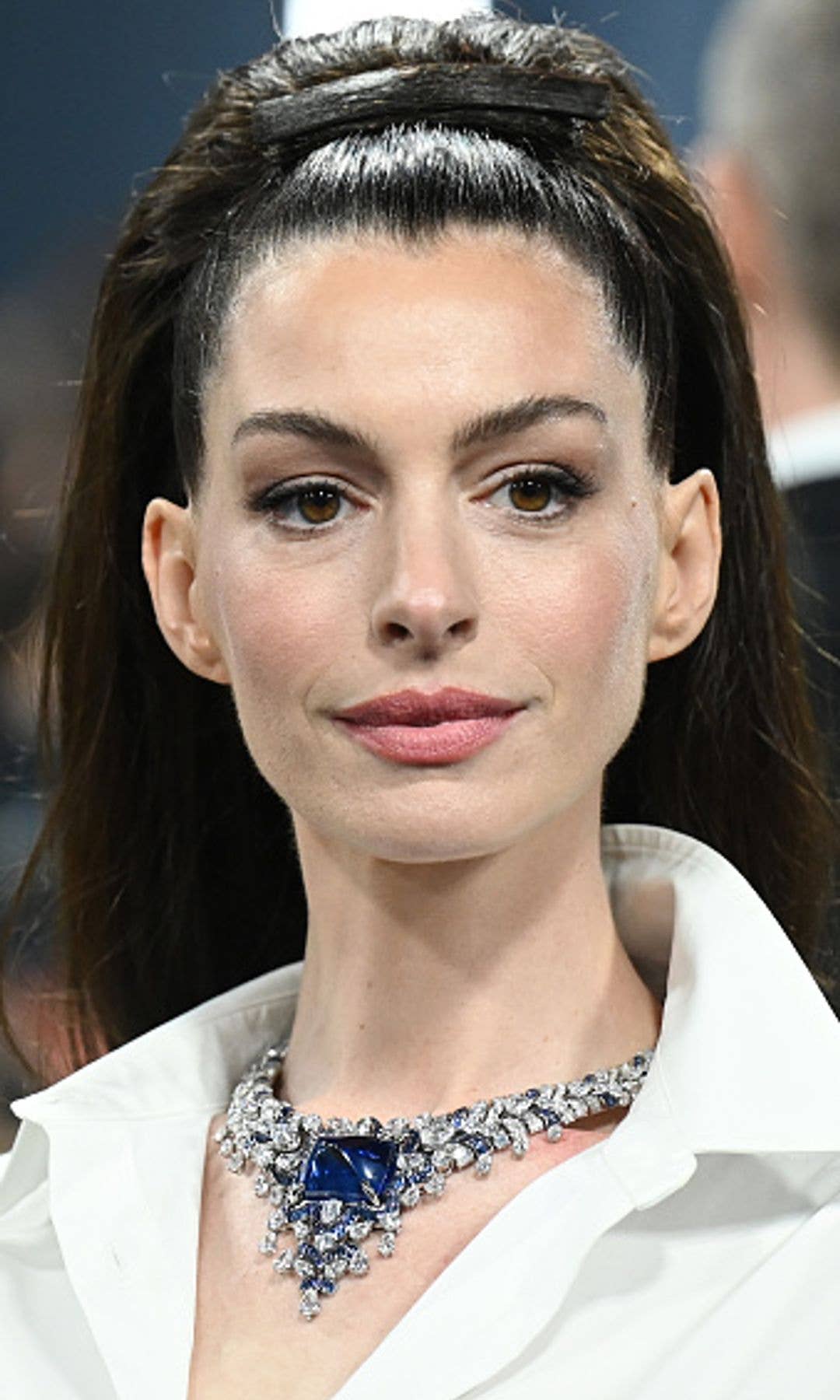 Anne Hathaway at The 2025 Met Gala with her hair scraped back with a hair clip made of hair