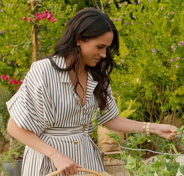 Meghan styled the dress with diamond earrings and her signature gold bracelet stack