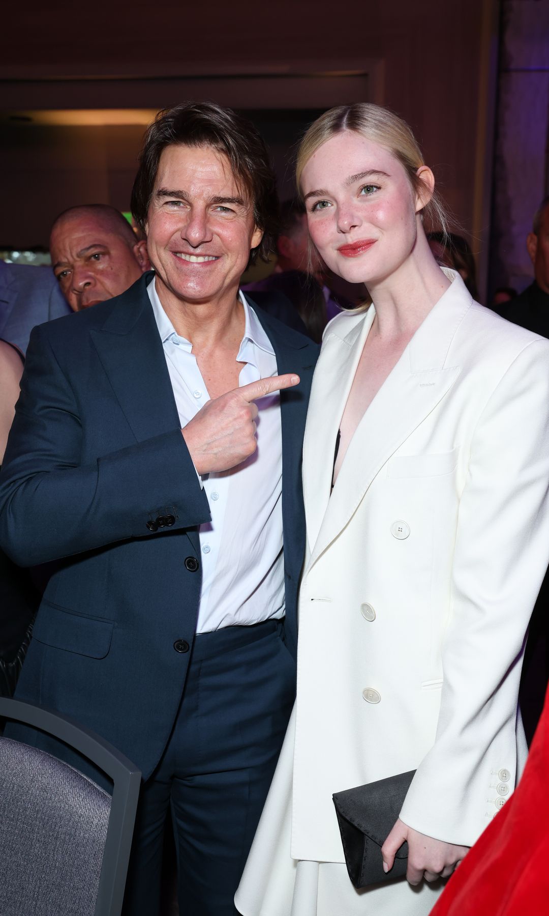 Cruise also posed with Elle Fanning, who's was nominated for her first Oscar this year