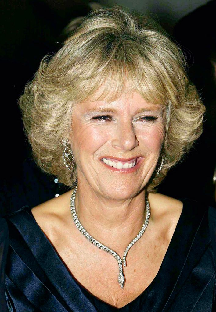 Queen Camilla in 2003 smiling in black dress