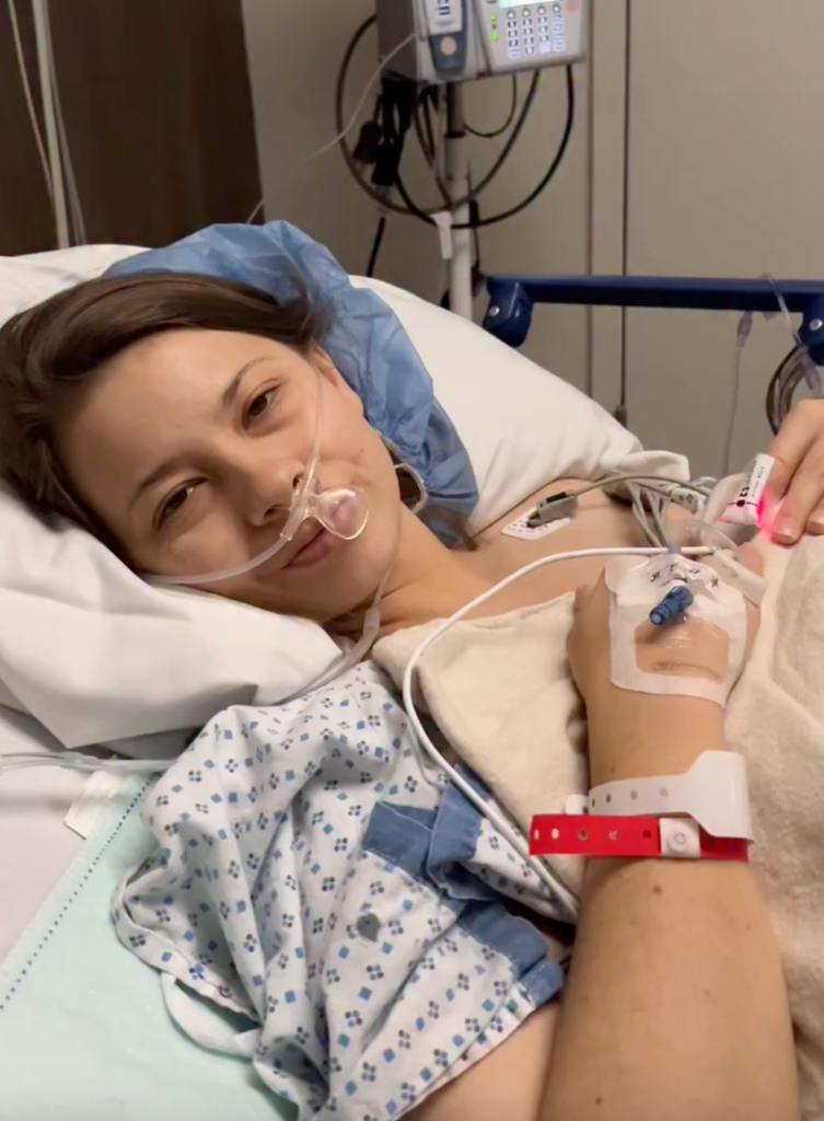 Bindi Irwin lying in hospital bed