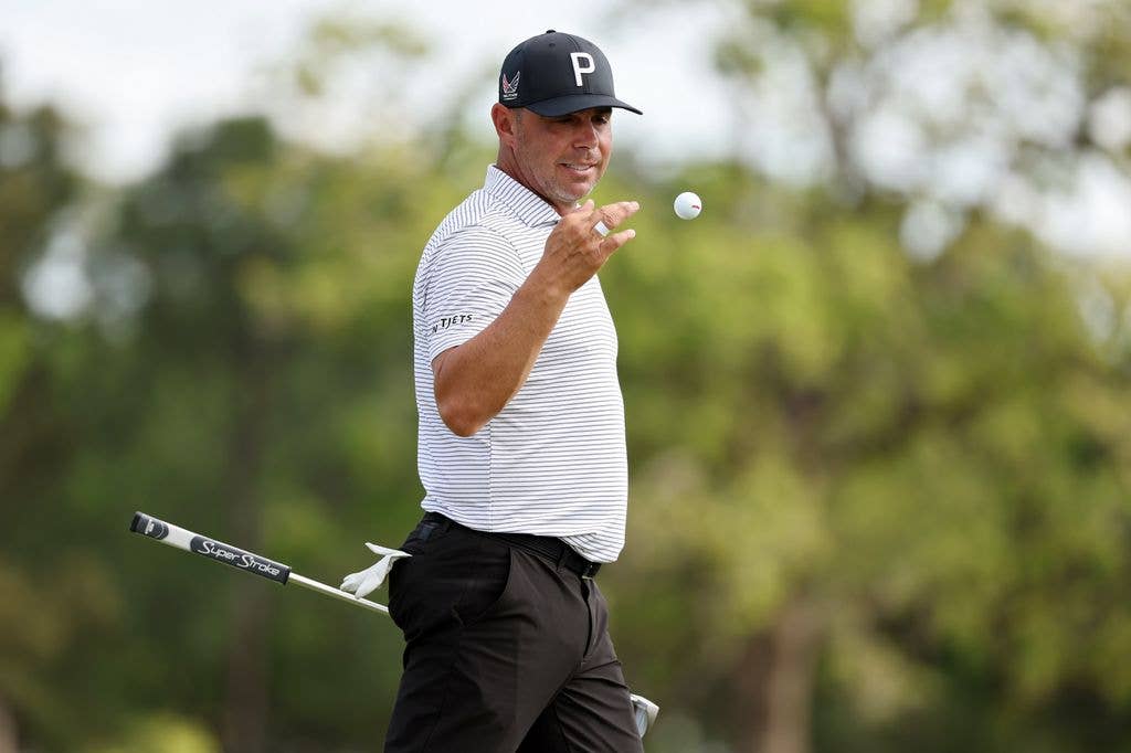 Gary on the golf course catching a golf ball